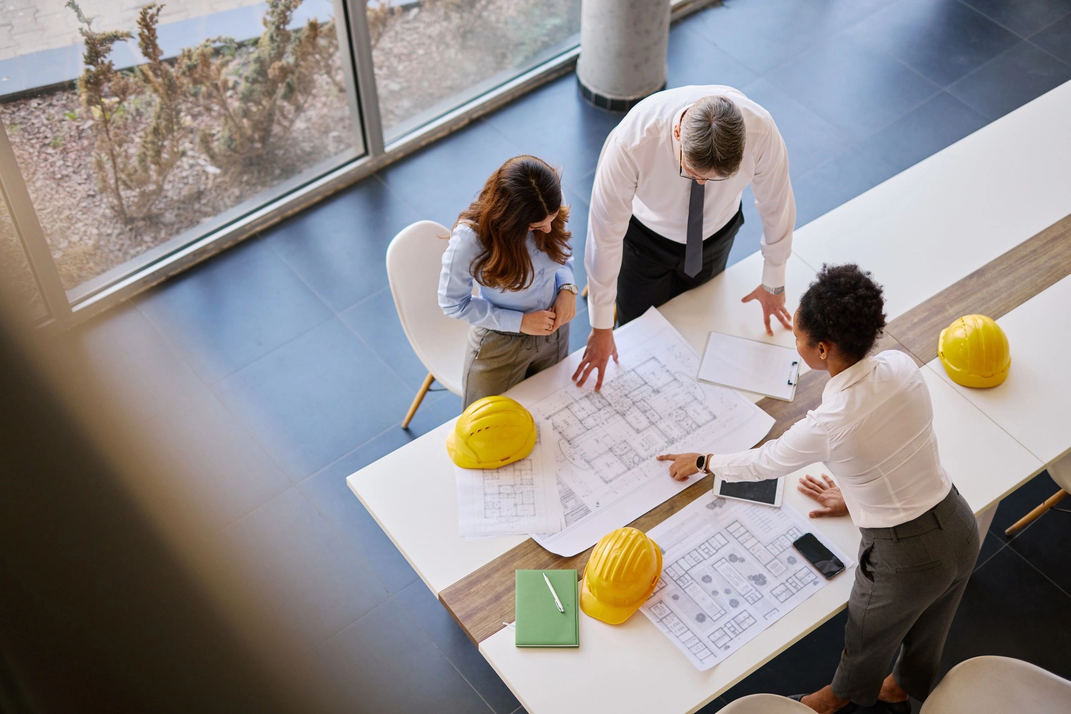Engineers reviewing plans and specifications at a table